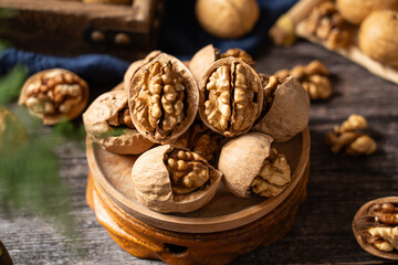 Walnuts are placed on a rustic old wooden table