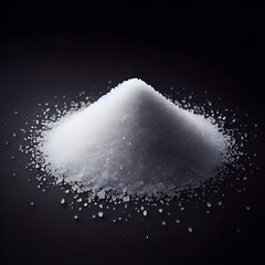 A pile of white granulated refined sugar on a black background