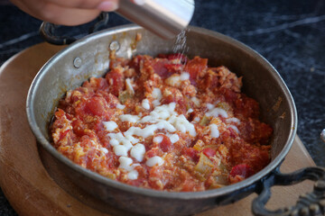 Turkish Menemen omelet in a frying pan. .