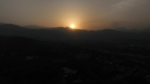  Aerial view to experience a breathtaking spectacle as the sun paints the sky in Uttarakhand, casting its golden glow over the majestic mountains in a captivating dance of dawn. 4k footage 