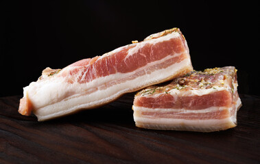 Appetizing salty lard with layers of meat. Salted lard with garlic and herbs.