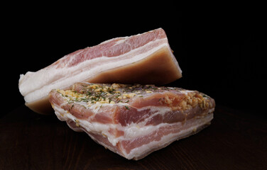 Appetizing salty lard with layers of meat. Salted lard with garlic and herbs.