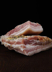 Appetizing salty lard with layers of meat. Salted lard with garlic and herbs.