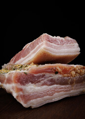 Appetizing salty lard with layers of meat. Salted lard with garlic and herbs.