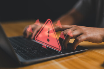 User is using computer with triangle caution warning sign for notification error and maintenance...