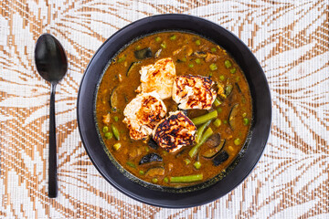plant-based vegetable green curry with fried silken tofu