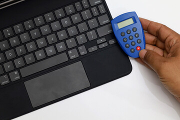 Token to generate password for online banking with blank screen notebook or computer for money transfer concept over internet