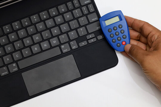 Token to generate password for online banking with blank screen notebook or computer for money transfer concept over internet