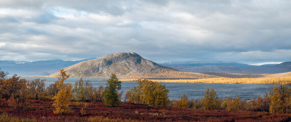 Autumn colors by the Lake Tornetr&auml;sk on a partly cloudy autumn afternoon, Swedish Lapland