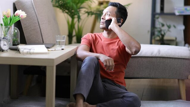 Man at home making phone call with his friend.