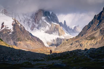 Tableaux ronds sur aluminium Cerro Torre A tiny woman standing alone in the Agostini campsite surrounded by mountain range in the morning with Mt.Cerro torre as background (Patagonia)