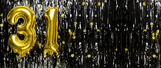 Gold foil balloon number number 31 on a background of black tinsel decoration. Birthday greeting...