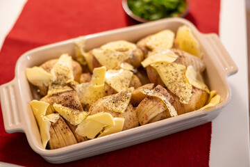 Stockholm, Sweden Sliced Hasselback potatoes with butter in an oven dish.readu for the oven.
