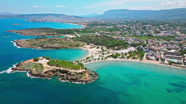 Aerial view of Stavros with turquoise water and sandy beach overlooked by craggy mountains in Crete, Greece. Drone view of Sandy Cove, an excellent spot for relaxing holidays in Greece.