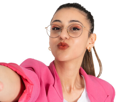 Taking selfie, young caucasian brunette businesswoman taking selfie. Sending air kiss to camera. Close up portrait. Transparent png image girl wearing formal pink jacket and glasses.