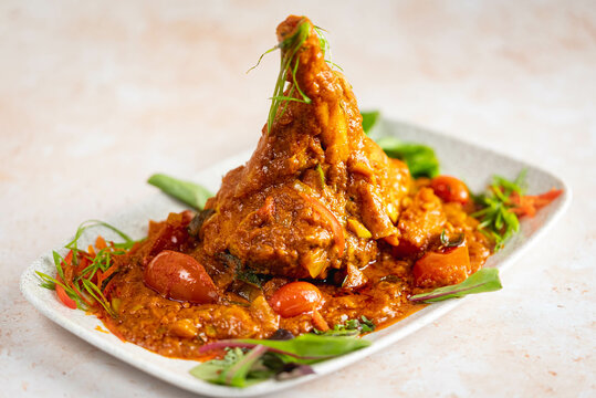 Spicy Lamb Shank with herbs and tomato sauce.