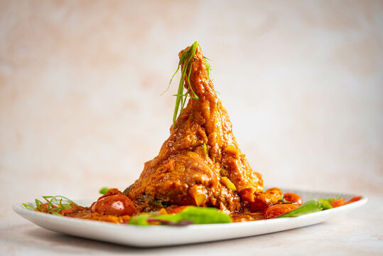 Spicy Lamb Shank with herbs and tomato sauce.