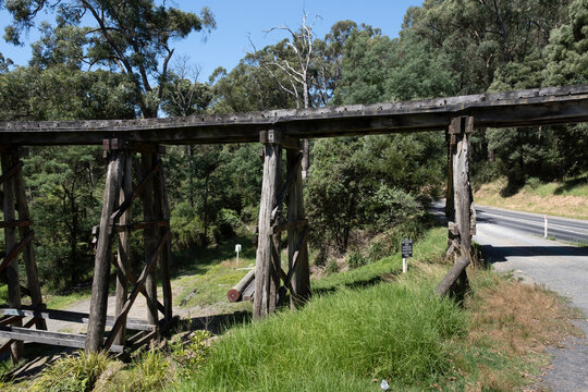 Side view of the wooden old Monbulk iconic Puffing Billy-Railway Trestle Bridge built in 1889, located in the Dandenong Ranges near Melbourne, Victoria, Australia over the road