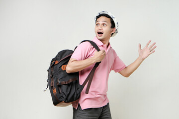 Asian man backpacker with shocked and sursprised expression. digital nomad and travelling concept. on isolated background