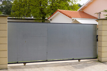 sliding gate steel big grey raw slide metal portal on modern house street view
