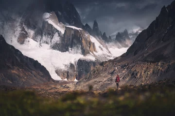 Fototapete Cerro Torre A tiny woman standing alone in the Agostini campsite surrounded by mountain range in the morning with Mt.Cerro torre as background (Patagonia)