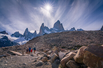 Group of people trekking to the campsite with Mt.Fitzroy as the background and fantastic sun and...