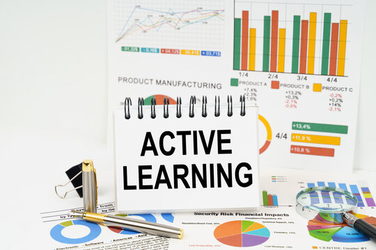 On the table are reports with graphs and a notepad with the inscription - ACTIVE LEARNING