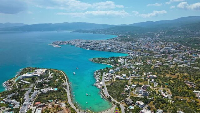 Havania Mirabello Beach in Agios Nikolaos Crete Greece on a sunny summer day. Aerial drone view of paradise alike location vacation houses resorts hotels in the Mediterranean with turquoise water