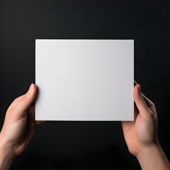 two hands holding blank paper sheet or letter paper