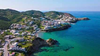Aerial view of tourist resort hotels and Livadi Beach in Crete, Greece. Luxury villas by Bali Seaside Village with turquoise crystal clear water on Greek Island.