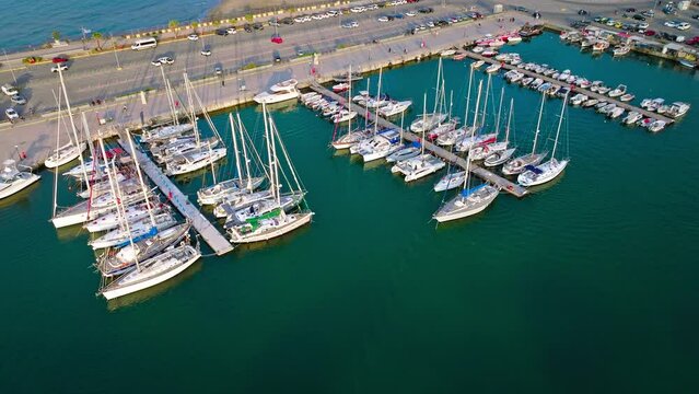 Aerial view of Rethymno Marina Venetian Harbor with fishing boats and lined with tavernas. Port of Rethymnon with ships and boats in Crete, Greece.