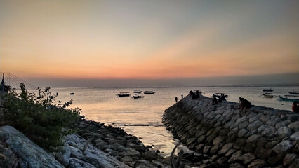 The view of the sunset in Nusa Penida is very beautiful and enchanting with an orange sky