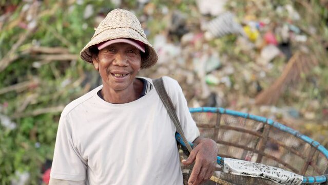 Portrait, asian waste picker or salvager at landfill with optimistic face, real people