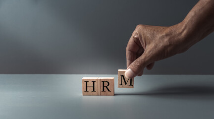 hand posing wooden blocks with HRM or human resources management , concept of human resources ,...