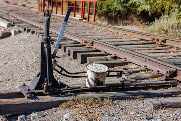 manual railroad switch with lever and counterweight at summer day.