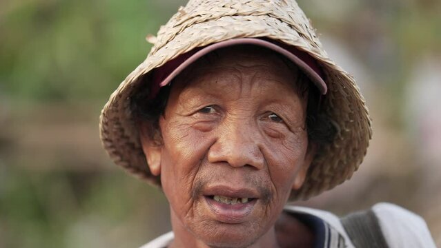 Portrait of male Asian garbage picker or scavenger facing economic struggle in rural asia