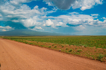 A dirt road against a mountain background at Ngorongoro Conservation Area in Tanzania
