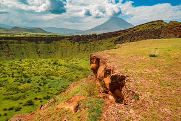 Scenic view of Shimo ya Mungu - The God's Pit with Mount Ol Doinyo Lengai in the background at the edge of Makonde Plateau in Tanzania