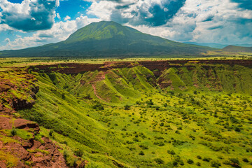 Scenic view of Shimo ya Mungu - The God's Pit with Mount Ol Doinyo Lengai in the background at the...