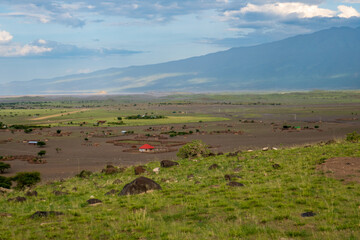 Obraz premium View of masai villages at the foothills of Mount Ol Doinyo Lengai in Tanzania