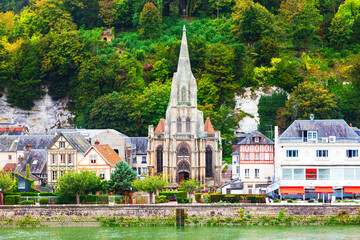 The coast of the Seine River in France in the suburbs of Rouen with beautiful private houses and dense green vegetation.