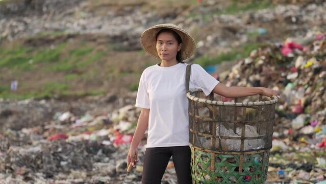 Portrait of female asian waste picker in landfill or rubbish dump in asia