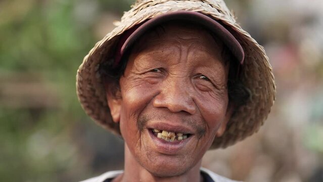 Happy old asian man with genuine and authentic smile in rural asia, laughter lines
