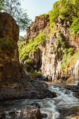 View of Ngare Sero river against rock formations at Ngorongoro Area, Tanzania