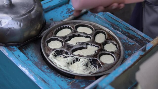 process of making spider cake or kue laba-laba, 4K video of street indonesian food
