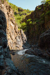 View of Ngare Sero river against rock formations at Ngorongoro Area, Tanzania