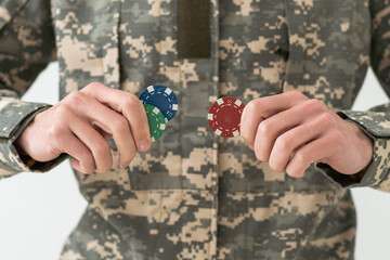 military man holding poker chips.