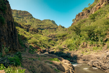 View of Ngare Sero river against rock formations at Ngorongoro Area, Tanzania