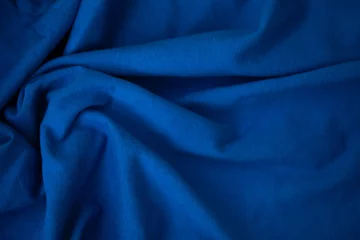 Fotobehang blue fabric with soft waves © Egor