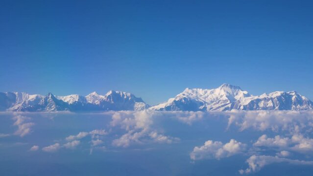 Watching the mountains covered with white snow shining from 16000ft high in the sky in Nepal